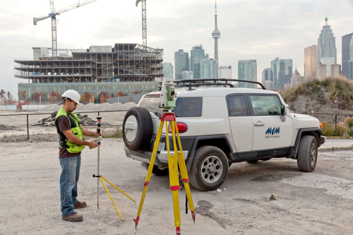 Surveyor recording precise site measurements